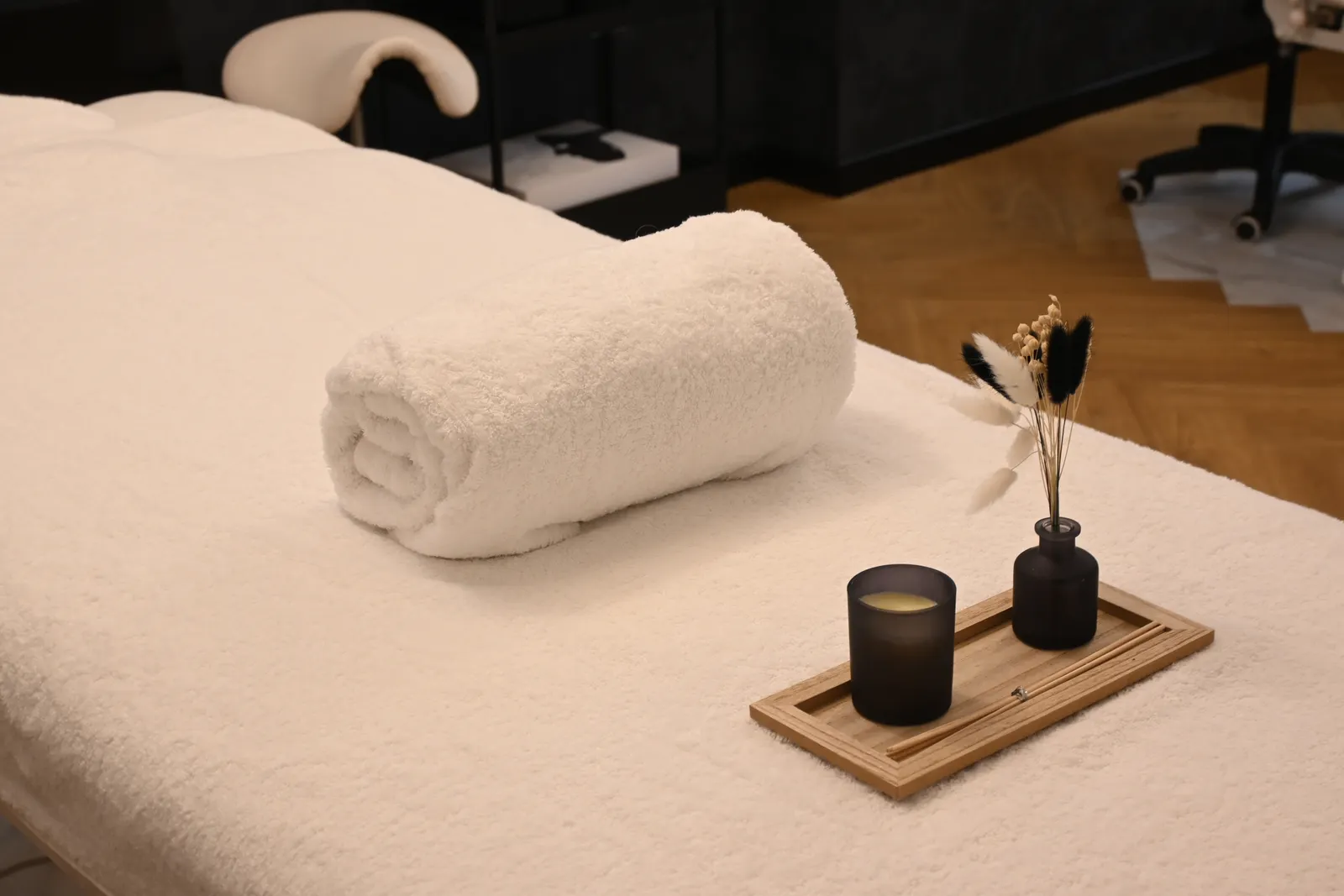 Treatment room with a folded towel and candle